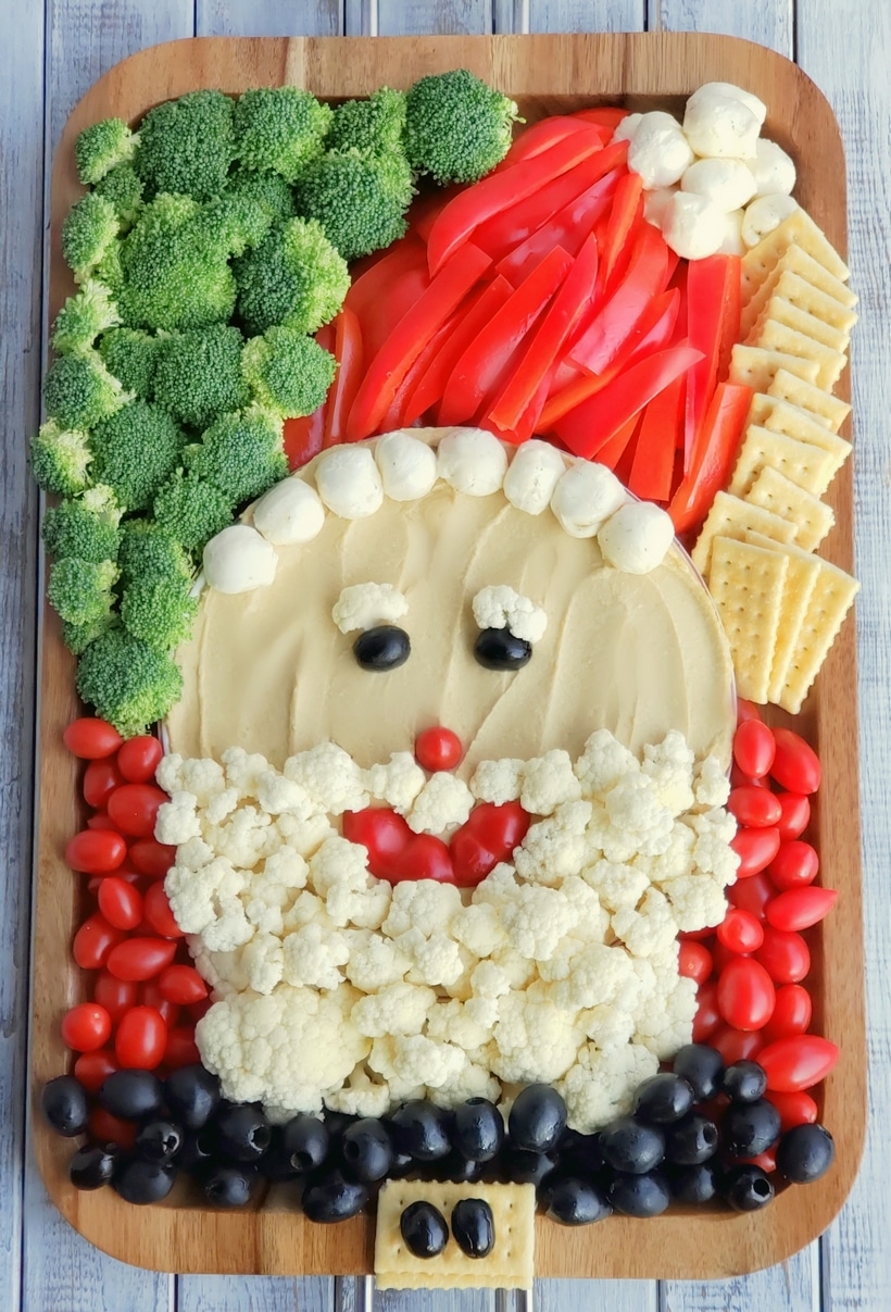 This Santa Snack Board is the perfect holiday centerpiece for every gathering this season. Not only is this healthy snack board festive and fun, it uses simple ingredients everyone loves. This Santa Board transports easily, feel free to take it along to every celebration this season. #noblepig #santasnackboard #diysantasnackboard #diy #healthysnackboard #christmas #christmasrecipes #easychristmasrecipes #holidayrecipes #santafood #santa #holidayentertaining #holidayfood #christmasappetizer via @cmpollak1