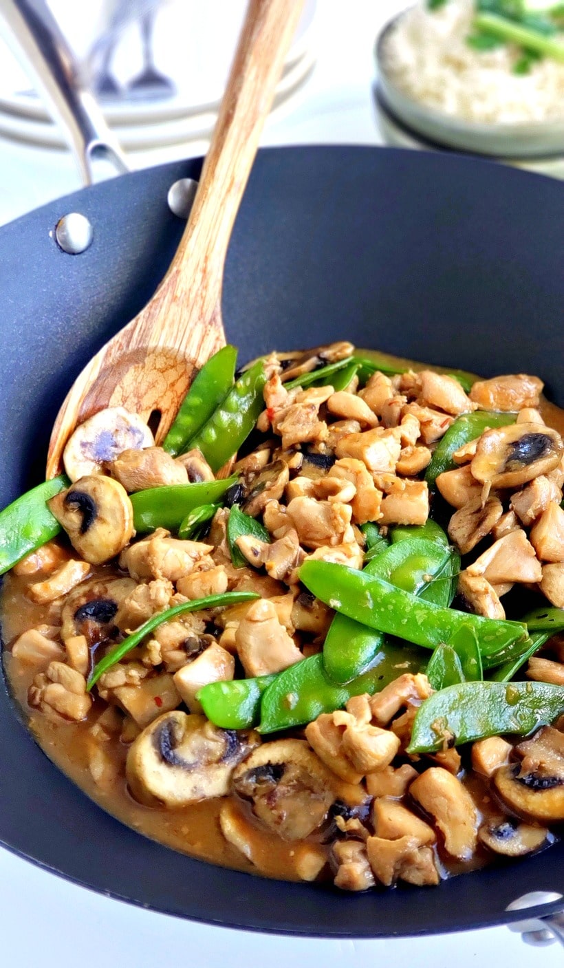 Chicken and snow pea stir-fry in a wok.