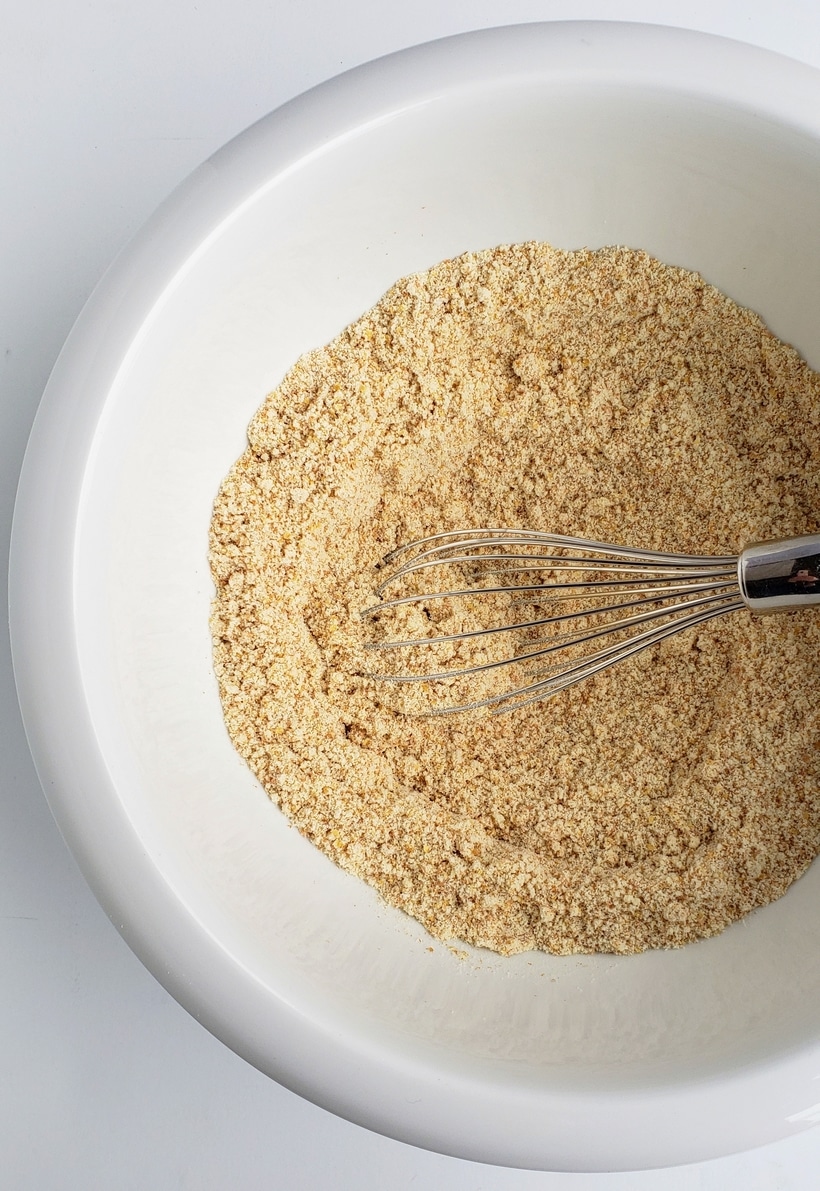 All flours in a bowl with a whisk.