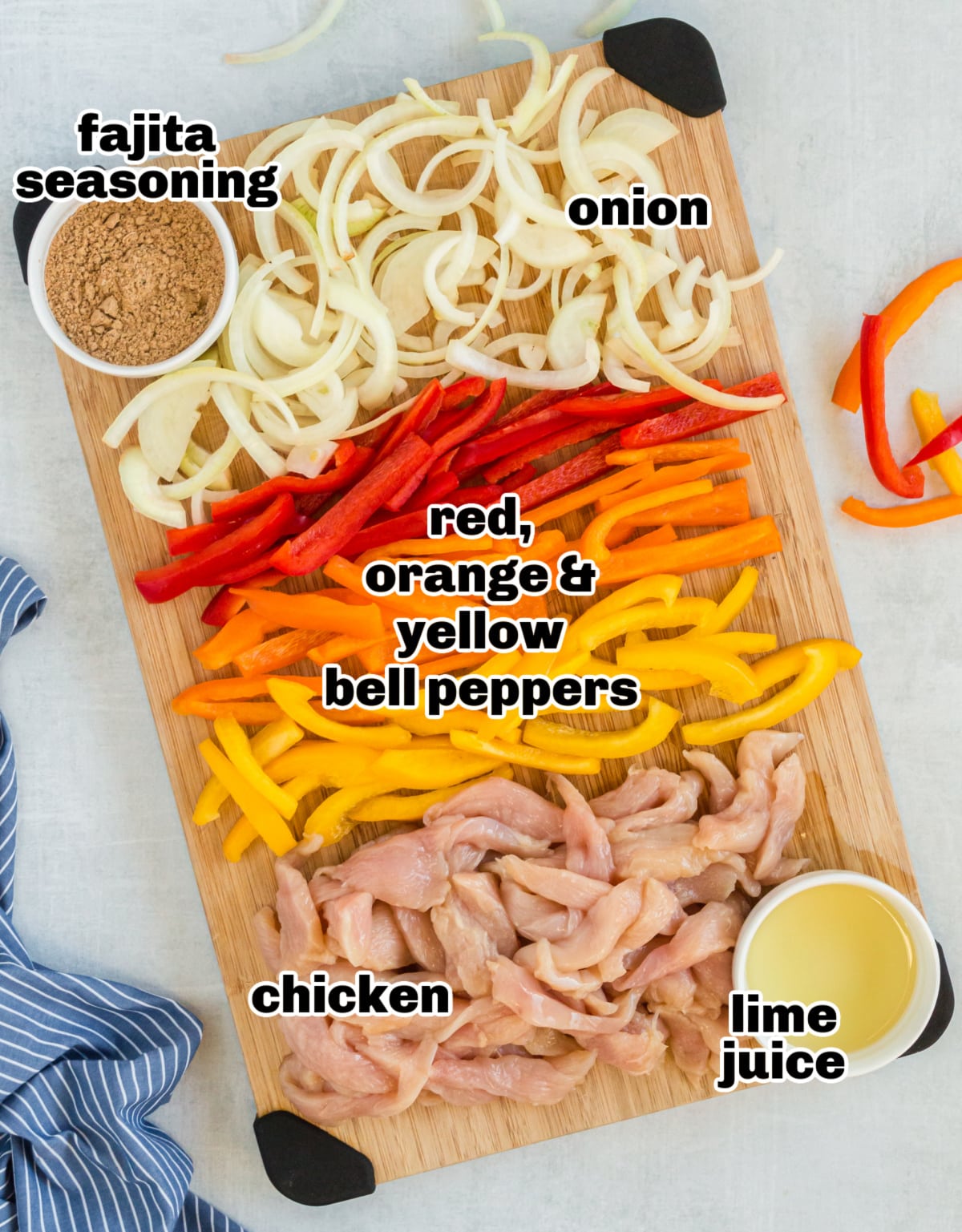 Sheet Pan Chicken Fajitas ingredients Raw ingredients for fajitas, including sliced bell peppers, onions, chicken, and seasonings, arranged on a countertop.