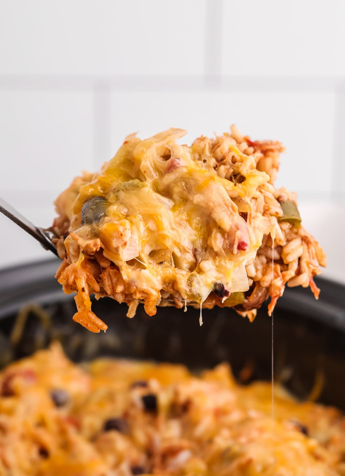 Burrito bowl being scooped out of the crockpot slow cooker chicken burrito Bowls