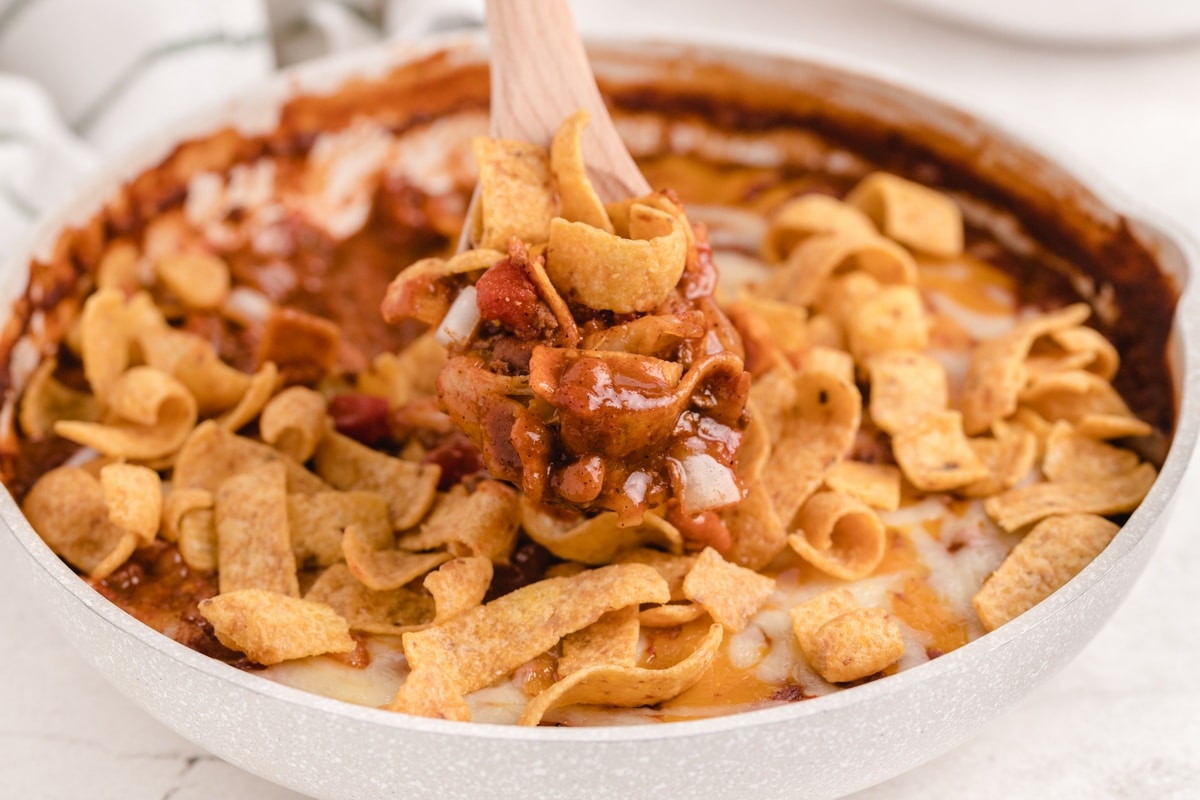 When I need a quick and easy meal (think fifteen minutes), I love making this super simple Frito pie right on the stove top. I use canned chili, unless I have a batch of leftover homemade chili available. It's the best and kids love it too. Frito pie on the stove