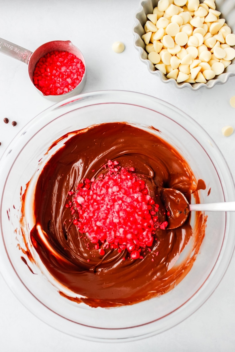 Making the Valentine's Day chocolate bark stirring cinnamon candies into the melted chocolate