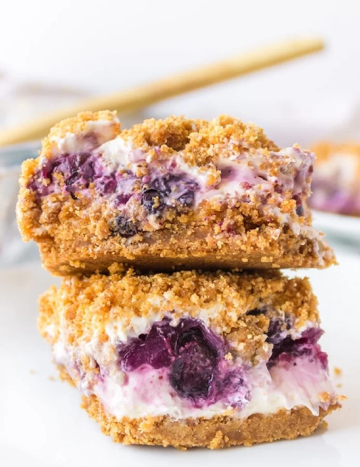 Close-up of stacked slices of Blueberry Cheesecake Icebox Cake Close-up of two stacked slices of blueberry cheesecake icebox cake showing creamy layers