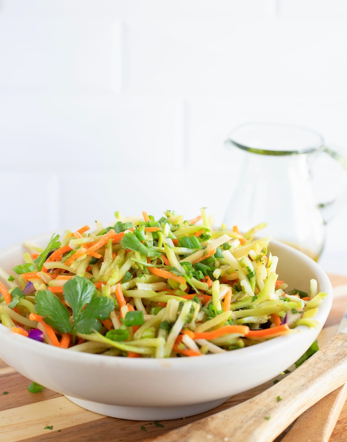 A bowl of Cilantro Lime Broccoli Slaw Bowl of freshly prepared cilantro lime broccoli slaw with vibrant green color and tangy dressing.