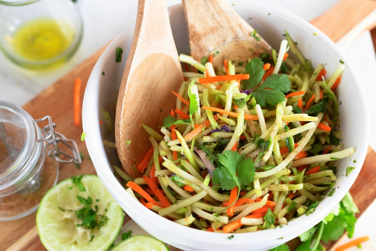 Cilantro Lime Broccoli Slaw in a mixing bowl Bowl of freshly prepared cilantro lime broccoli slaw with vibrant green color and tangy dressing.