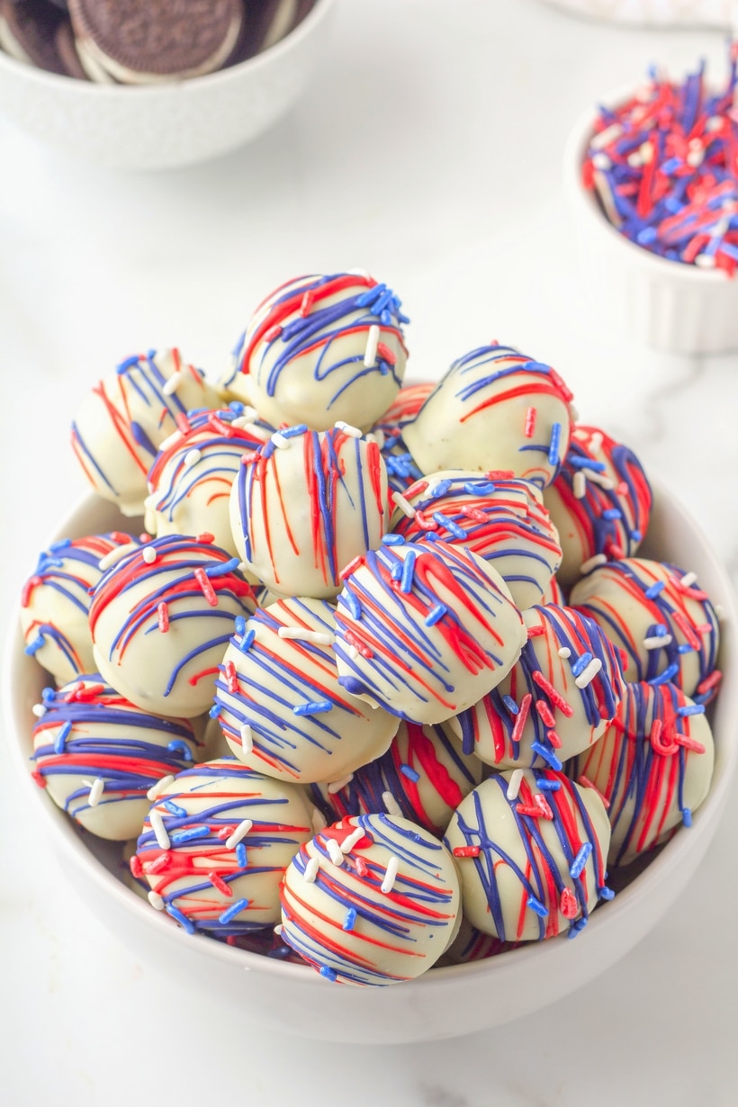 Patriotic Oreo Balls - they're a fine line between cookie and candy, but festive all the same. These star-spangled desserts are easy to make and perfect for patriotic celebrations. Think 4th of July and any other red, white and blue holiday. Colors can be switched out to make them fit every occasion. They taste like a chocolate truffle! patriotic oreo balls