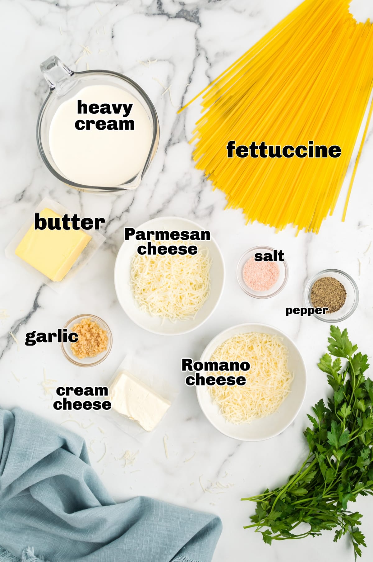 Ingredients for fettuccine alfredo. Ingredients for fettuccine alfredo: fettuccine pasta, butter, garlic, heavy cream, cream cheese, Parmesan cheese, and black pepper.