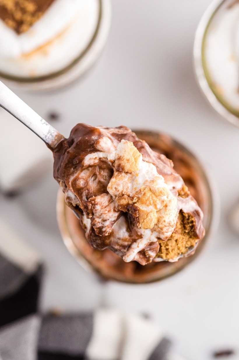 Spoonful of s’mores pudding parfait showing creamy chocolate, marshmallow, and graham cracker texture