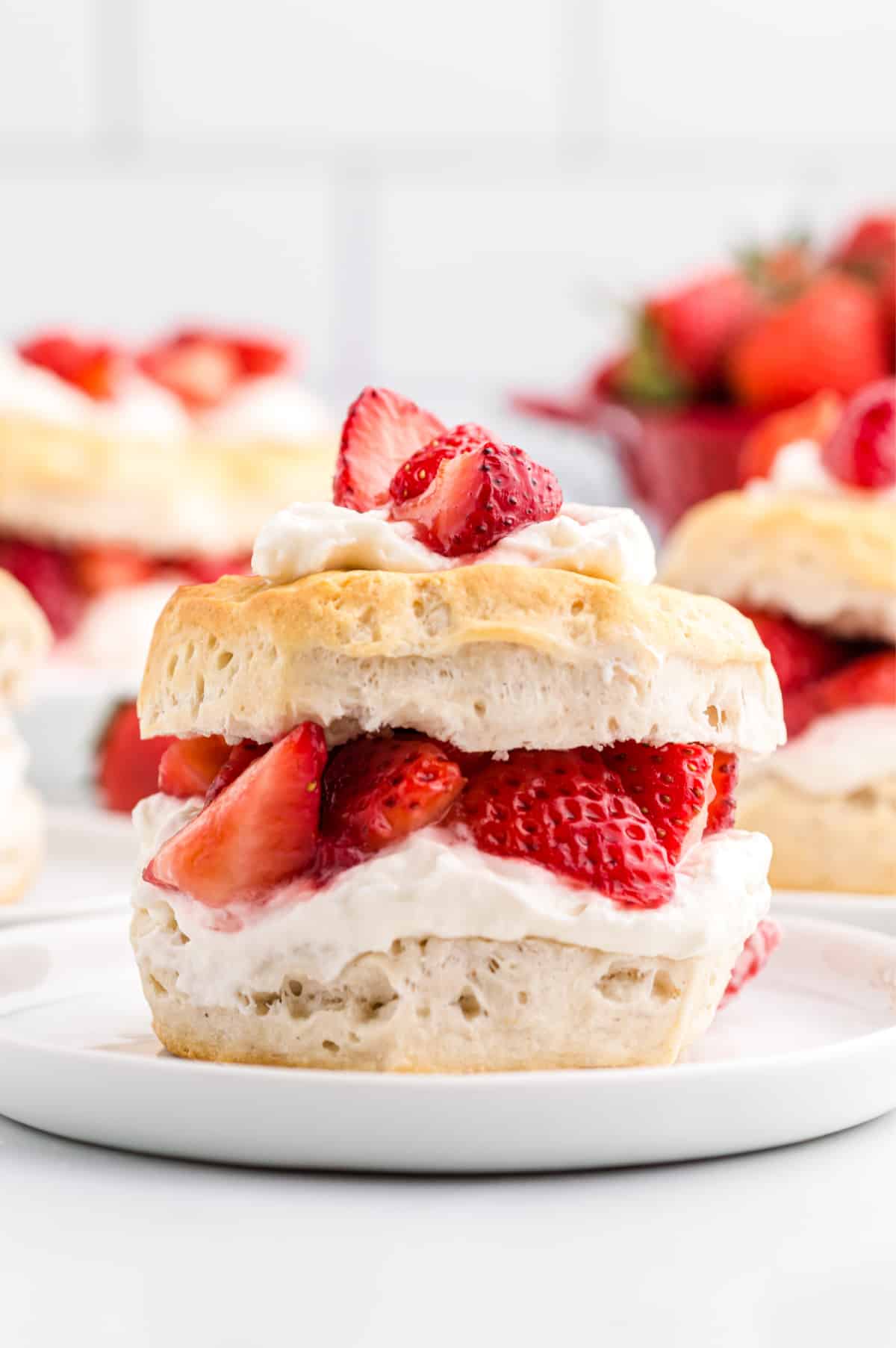 easy strawberry shortcake with whipped cream and fresh strawberries on a biscuit