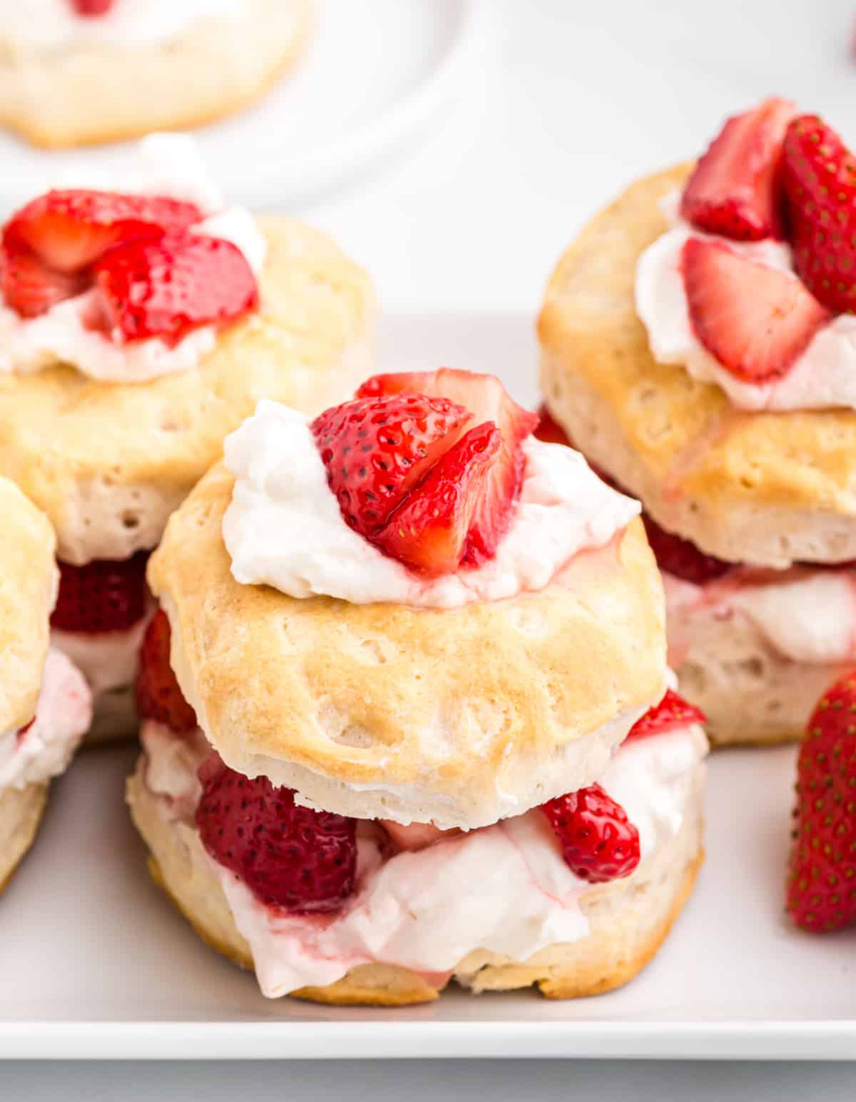 strawberry shortcake with whipped cream and fresh strawberries on a biscuit