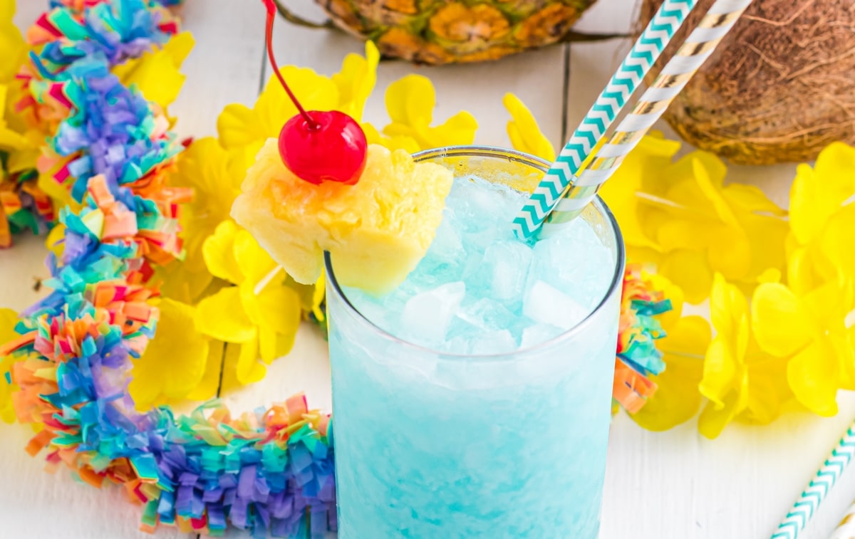 This blue Hawaiian cocktail tastes like a vacation in a glass. With pineapple, coconut, and a splash of blue curaçao, it’s perfect for summer parties or serving at a luau! bright turquoise blue Hawaiian cocktail shown in a glass on a white surface