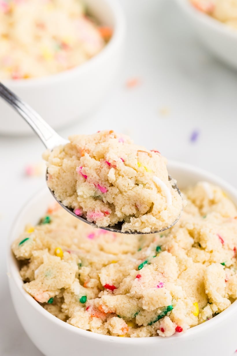 Edible Sugar Cookie Dough scooped from a bowl A spoonful of sugar cookie dough being lifted from the bowl, showing its soft and creamy texture.