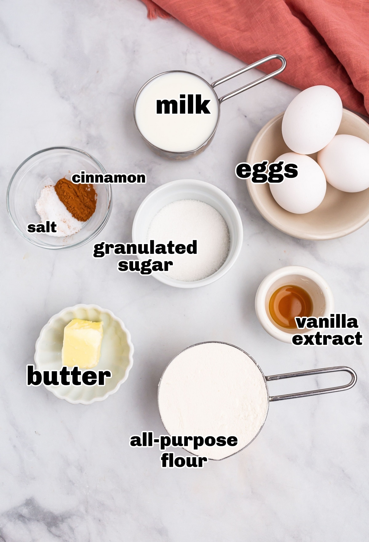  Ingredients for making a Dutch baby pancake laid out on a counter