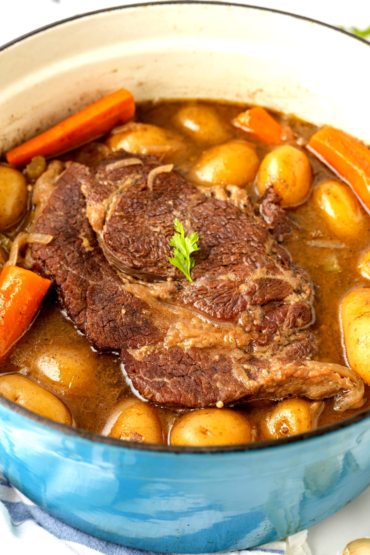 Pot roast cooking in Dutch oven with vegetables Close up of pot roast cooking on the stovetop with tender vegetables.