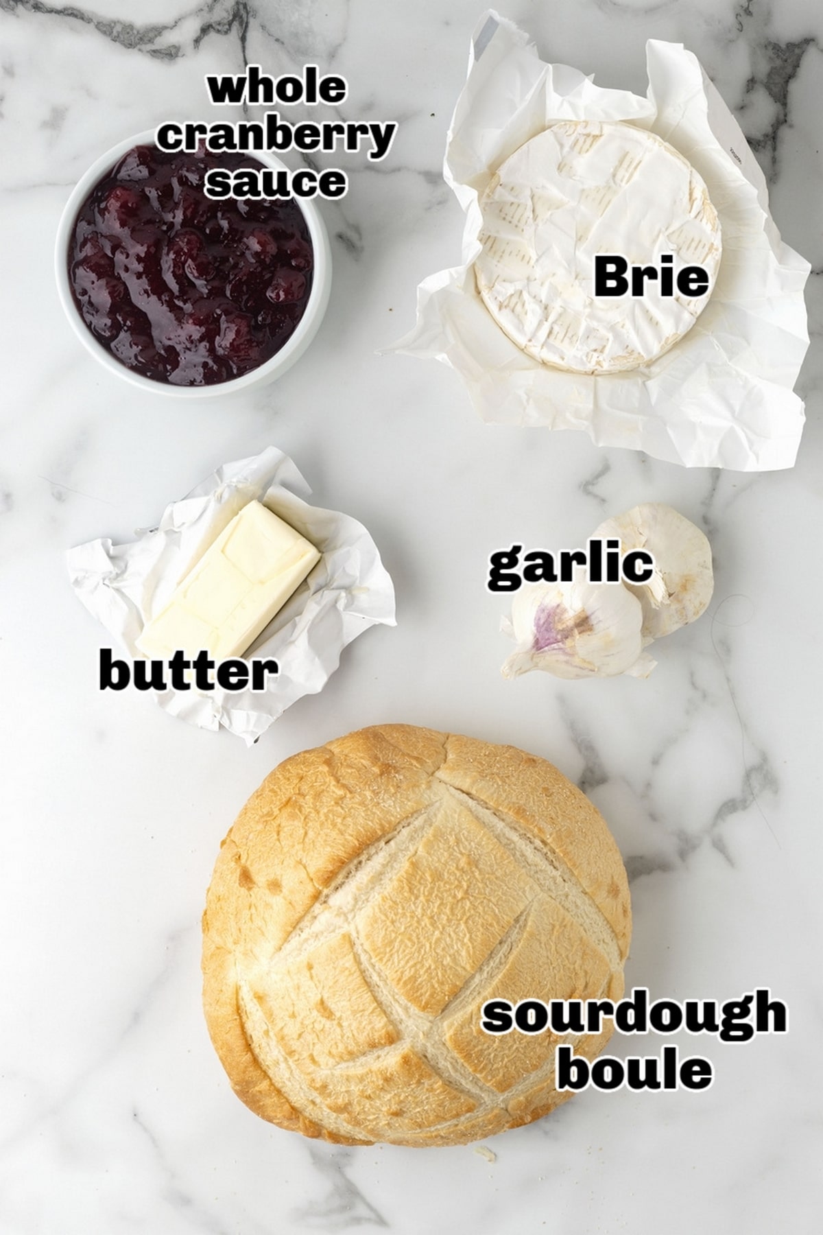 Ingredients for cranberry Brie pull-apart bread, including cranberries, Brie, and sourdough