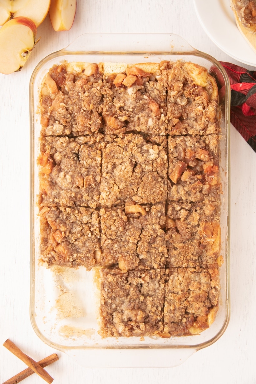 Apple Pie French Toast Bake in 9x13 Pan Baked apple pie french toast bake topped with brown sugar crumble.