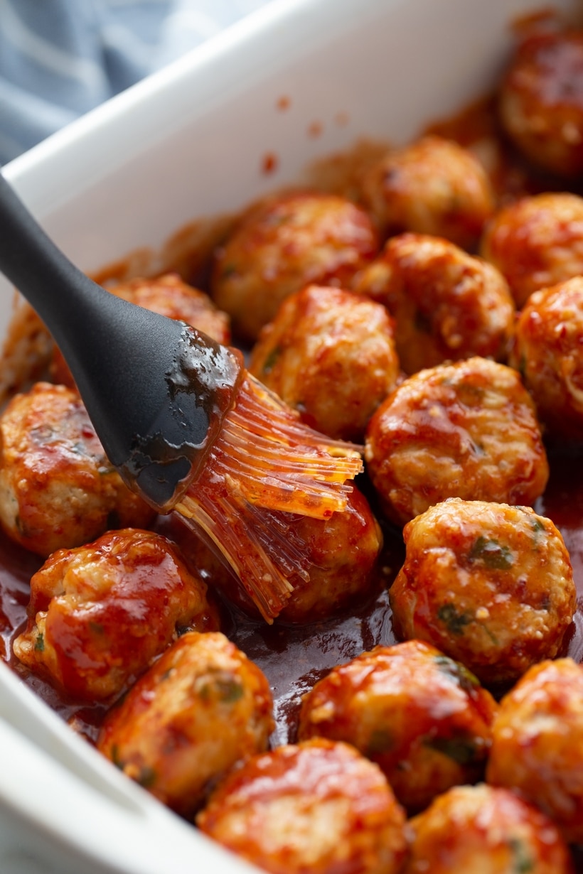 Chicken meatballs topped with spicy chipotle-honey sauce and cilantro." These descriptions provide clear context for both accessibility and user engagement, enhancing the overall user experience. Pan of chicken meatballs drizzled with chipotle-honey sauce, garnished with fresh cilantro.