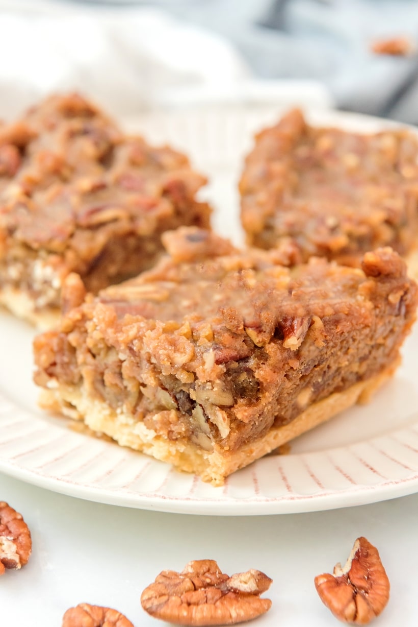 These pecan pie bars pack all the classic flavor of pecan pie into easy, bite-sized squares with a buttery shortbread crust. Perfect for serving a crowd—no pie making skills are necessary for this recipe. pecan pie bars