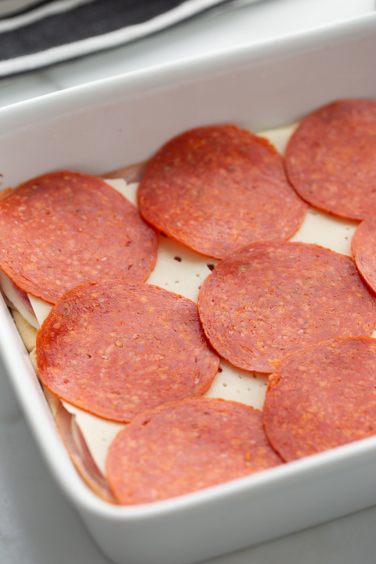 Genoa salami slices in a baking pan 