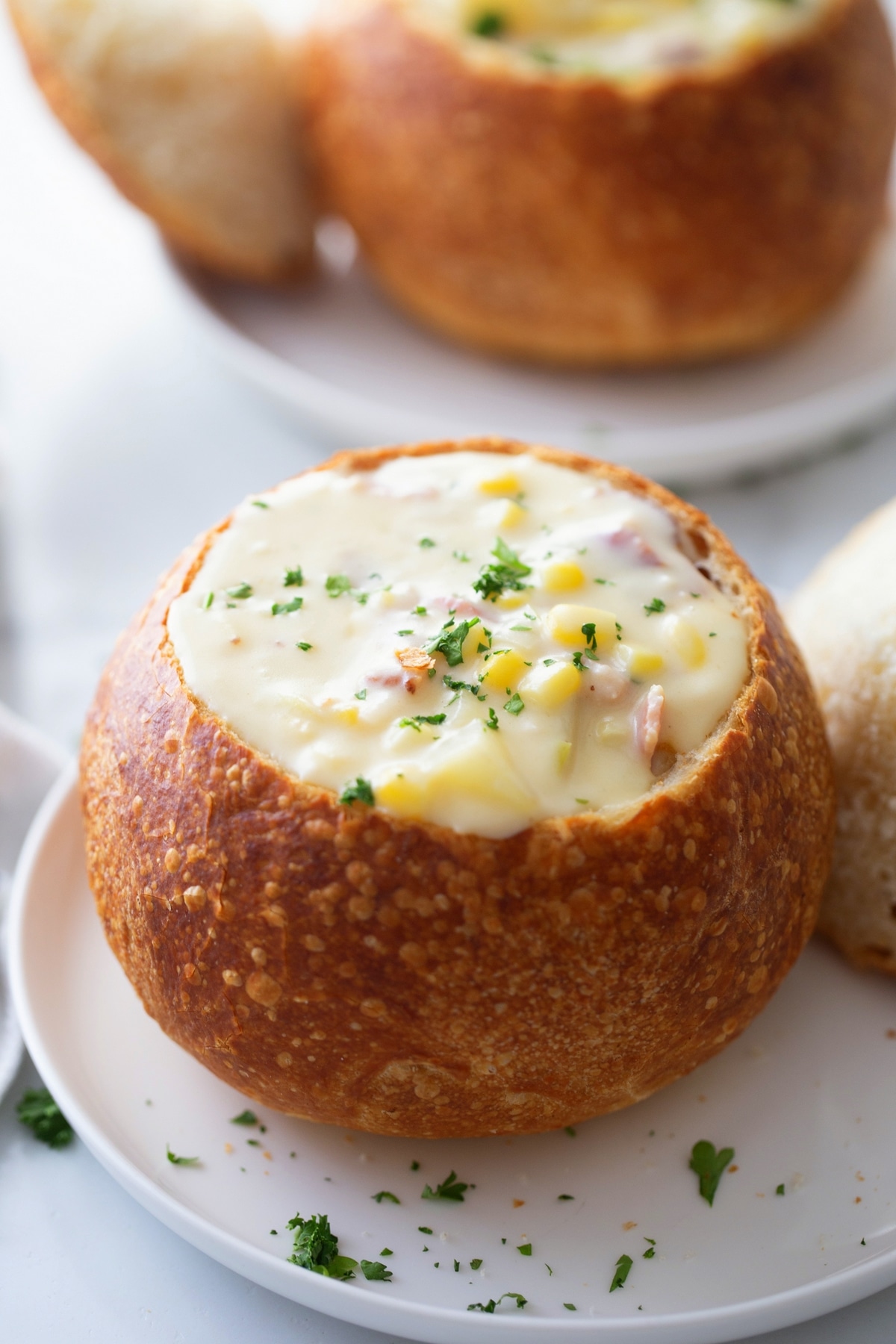 Homemade corn chowder in a sourdough bowl Corn chowder served in a sourdough bowl, ready to eat