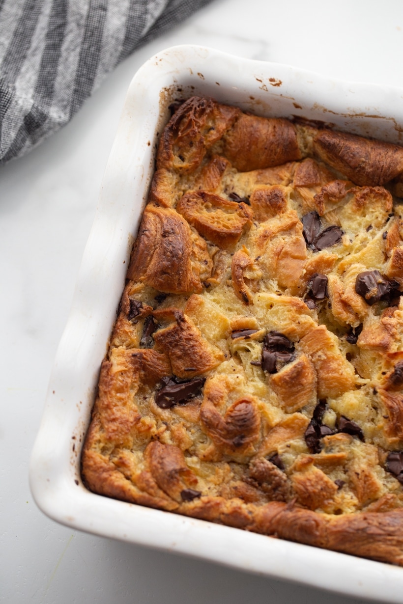Chocolate Croissant Bread Pudding baked A whole baked chocolate croissant bread pudding in a dish, golden brown on top and slightly puffed from the oven.