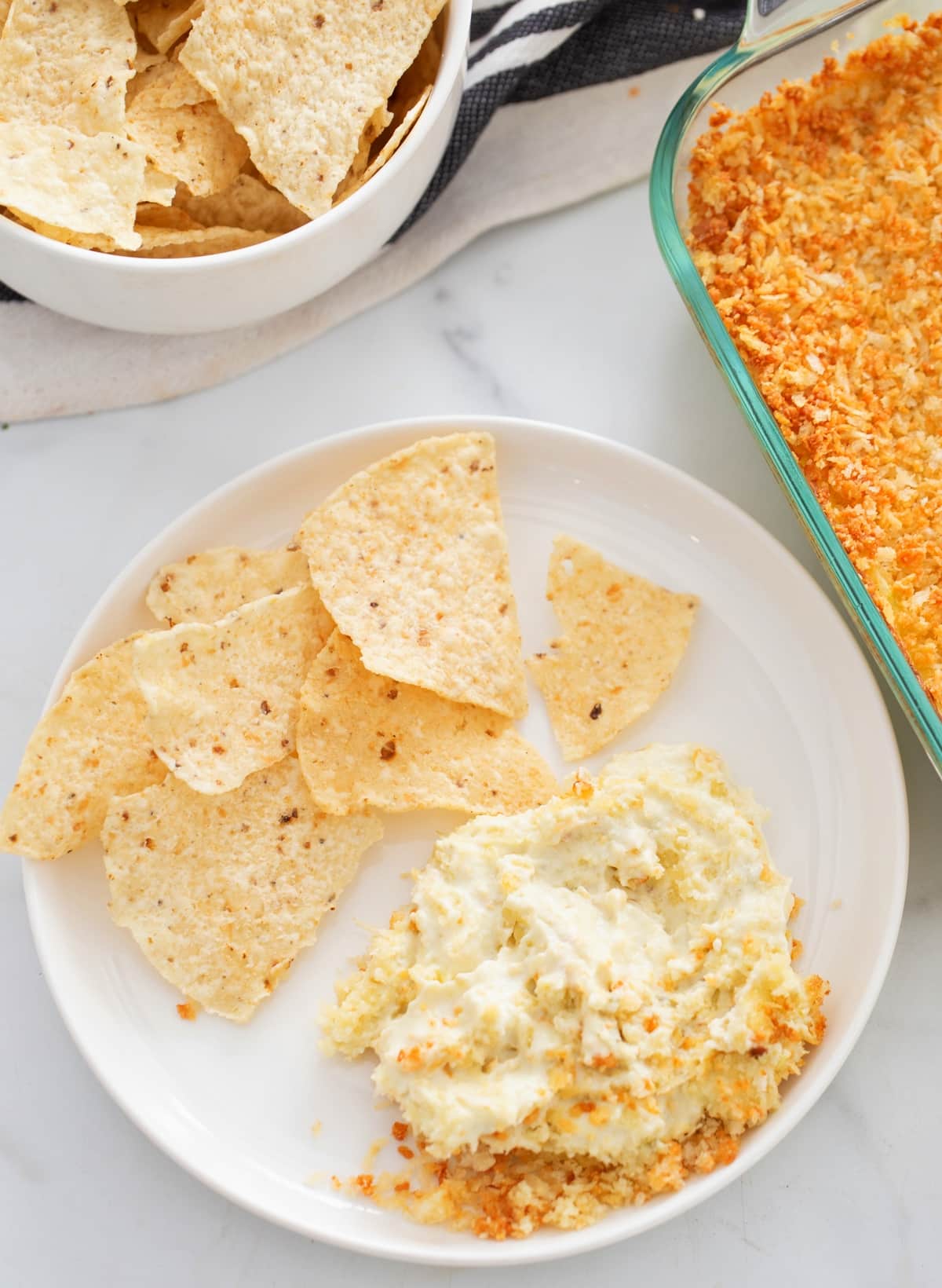 Jalapeno Popper Dip on plate with chips Jalapeño Popper Dip on a plate with chips