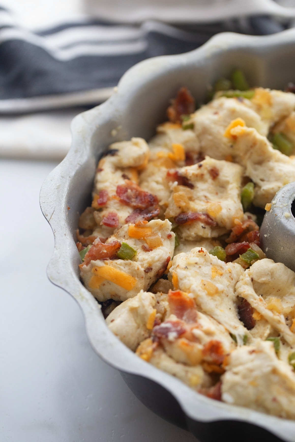 Pull-Apart Bacon Bread savory monkey bread pull-apart bacon bread in a Bundt pan before cooking