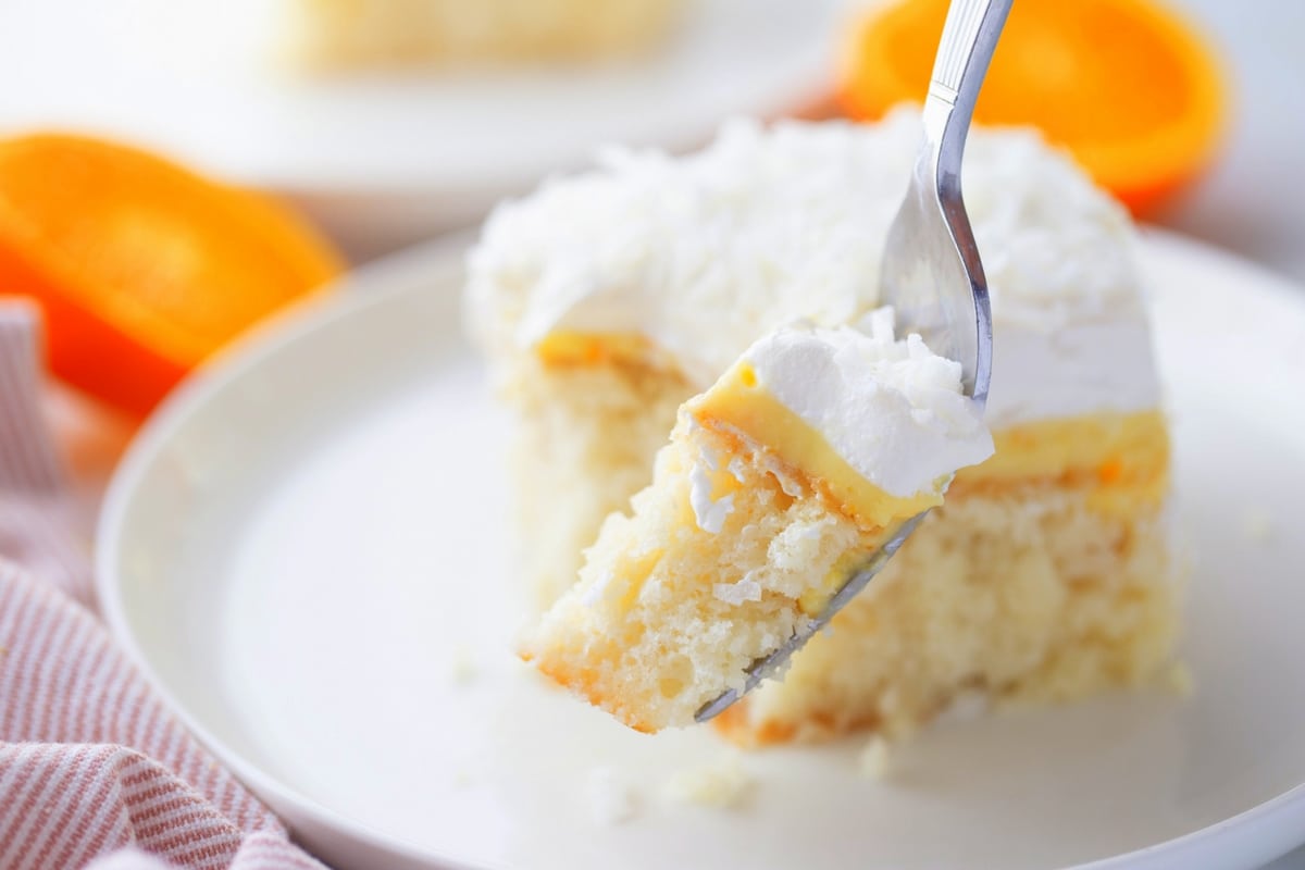 This is my idea of the dreamiest version of an orange creamsicle poke cake, thanks to the addition of cream of coconut in the cake batter. I've added a layer of intense orange curd, which adds brightness and a zesty taste to every bite. poke cake