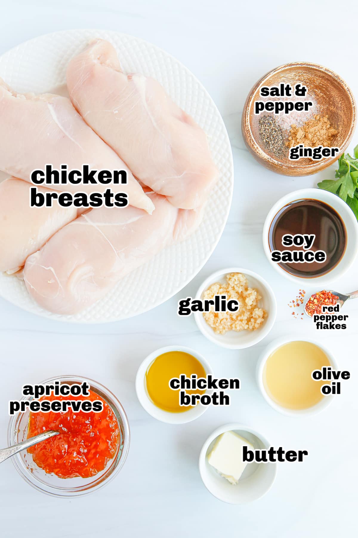 Apricot Glazed Chicken Breasts ingredients A display of ingredients, including apricot preserves, soy sauce, garlic, and seasonings, arranged on a countertop.