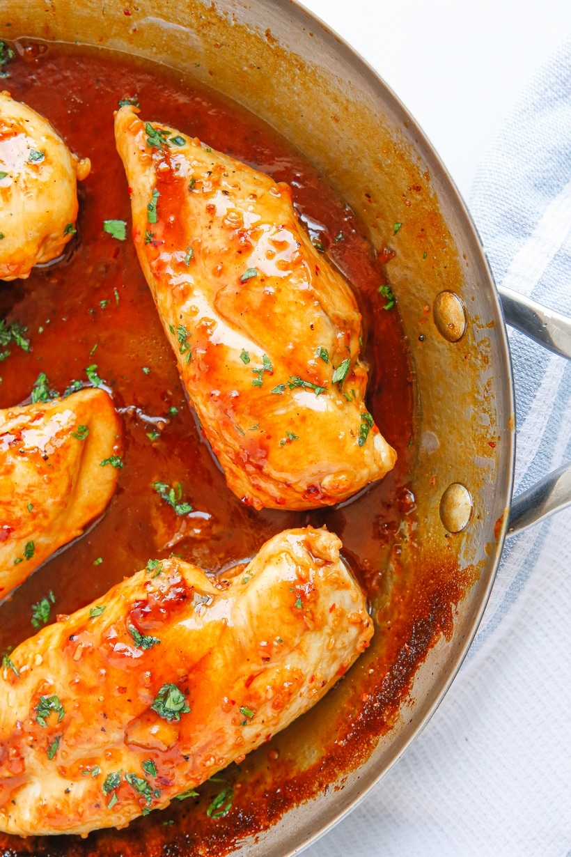 Apricot Glazed Chicken Breasts in a skillet A pan of golden-brown chicken breasts covered in a rich apricot glaze.