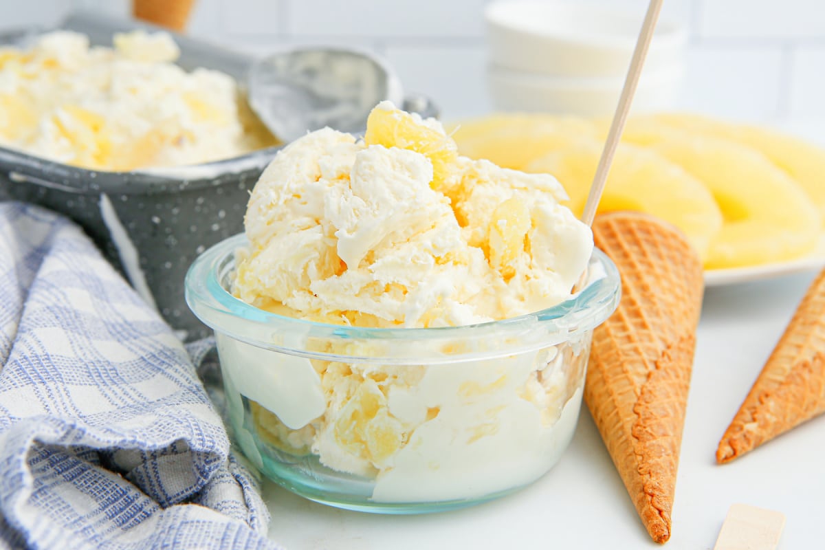 Pineapple ice cream in a glass bowl, ready to serve Creamy no-churn pineapple ice cream packed into a clear glass bowl