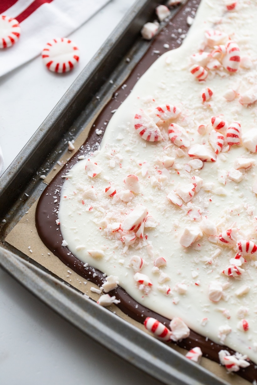Whole Peppermint Bark Slab on a Baking Tray Whole slab of double chocolate peppermint bark on a baking tray before breaking into pieces.