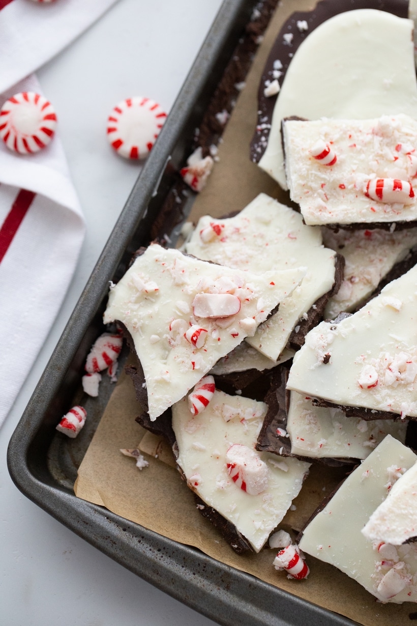Peppermint Bark Pieces on a Baking Tray Broken pieces of double chocolate peppermint bark scattered on a baking tray.