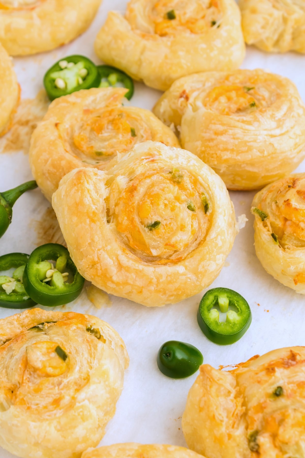 Jalapeno Popper Pinwheels with fresh jalapenos Golden, flaky Jalapeño Popper Pinwheels fresh out of the oven, with cheese bubbling and pastries slightly browned.