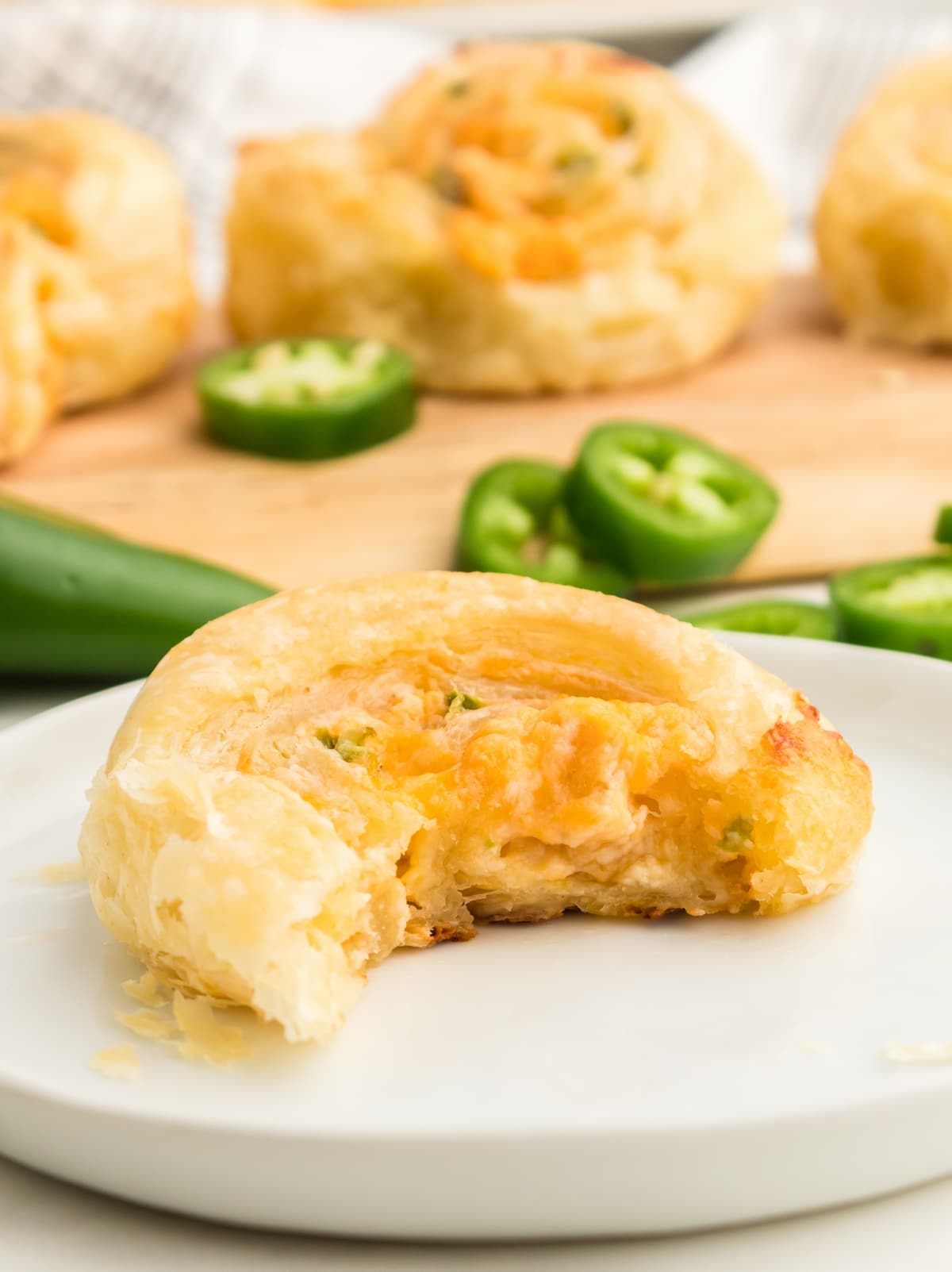 Jalapeno Popper Pinwheels on a plate A plate of Jalapeño Popper Pinwheels, perfectly sliced, showcasing the creamy cheese and jalapeños wrapped in flaky pastry.