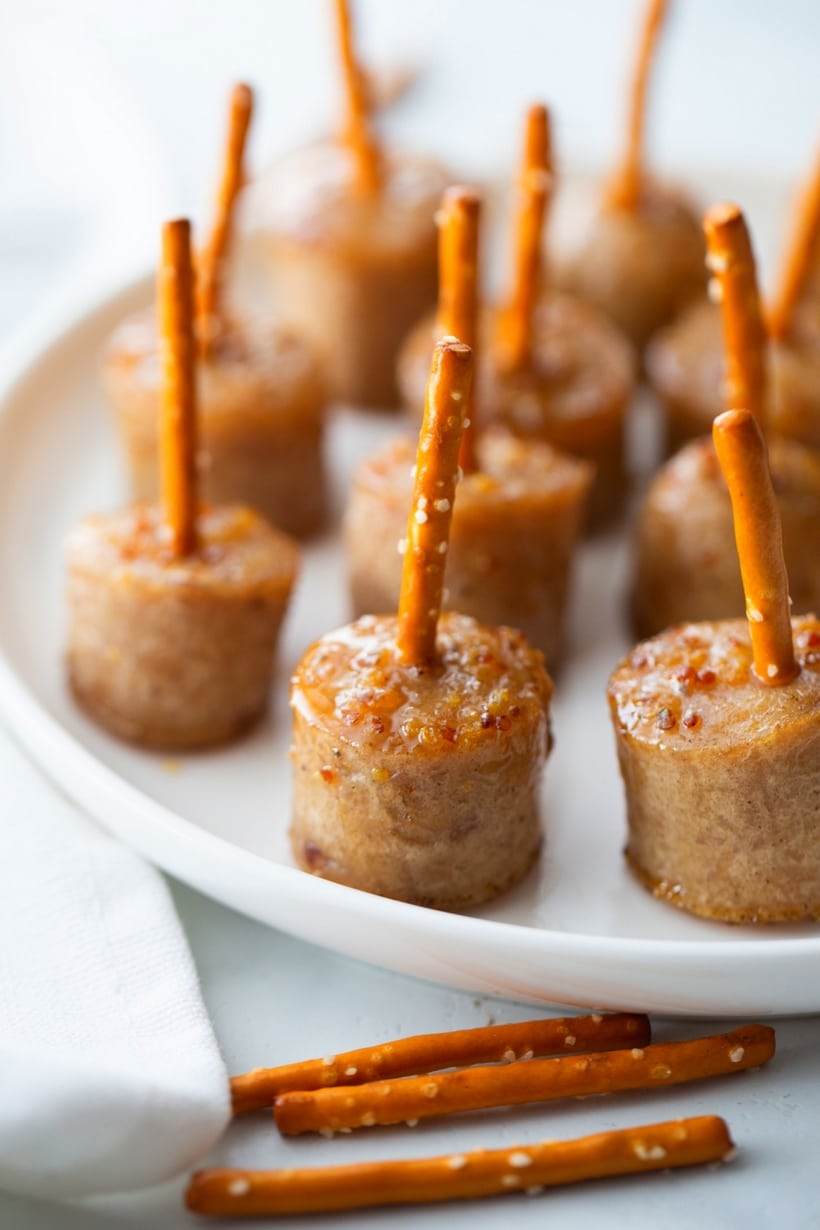 Maple-glazed chicken sausage bites skewered with pretzel sticks – easy appetizer for parties.