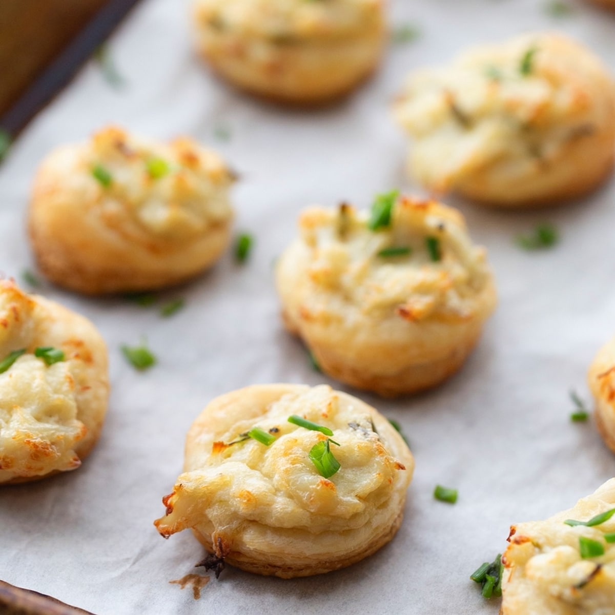 Finished Crab and Chive Puffs on a baking tray. crab and chive puffs on a baking tray