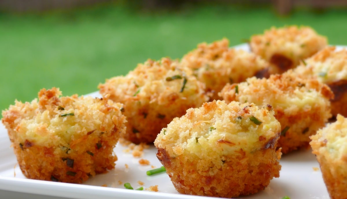 Mini Crab Cakes on a platter. Mini crab cakes arranged on a white platter.