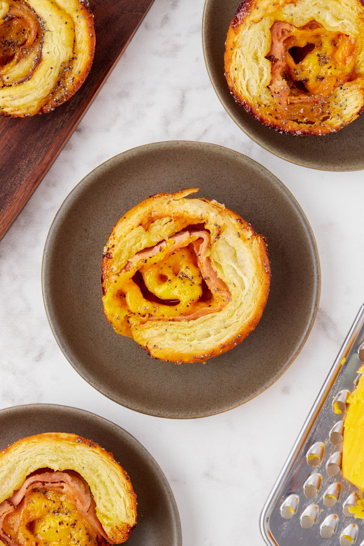 Ham and cheese pinwheels served on a platter, perfect for snacking. Bite-sized ham and cheese pinwheels served on a platter, perfect for snacking.