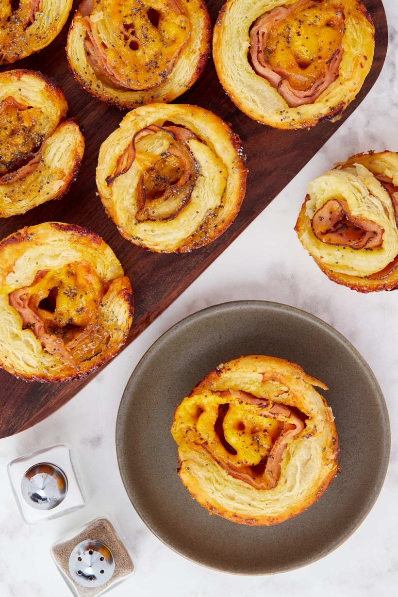 Ham and Cheese Pinwheels top view Close-up shot of golden brown ham and cheese pinwheels on a plate.