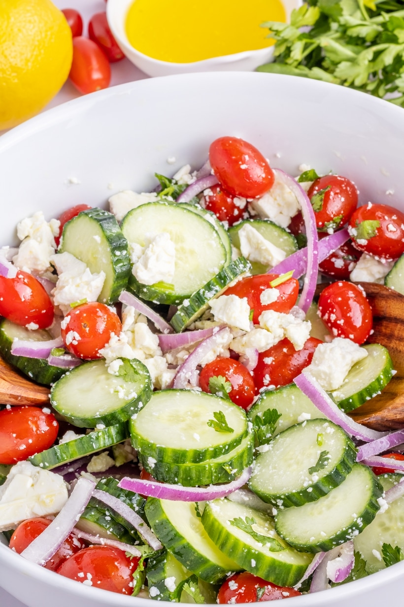 Mediterranean cucumber feta salad that's ready to eat. Fresh cucumber feta salad with cherry tomatoes, red onions, and feta cheese.