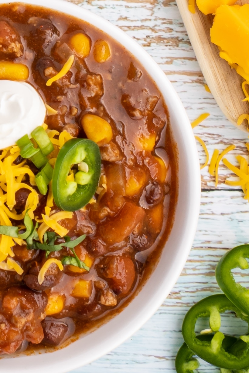 Taco soup in a bowl. Overhead of taco soup in a white bowl.