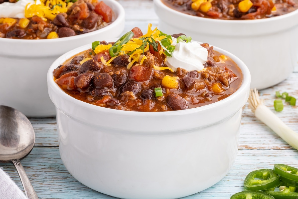 Three bowls of taco soup. Taco soup, three bowls with toppings.