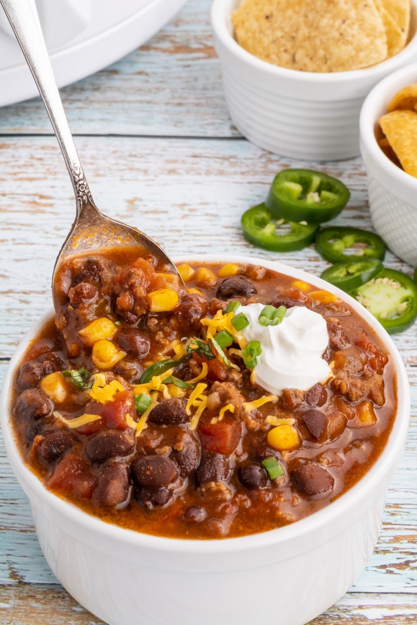 A spoonful of taco soup. a spoonful of taco soup
