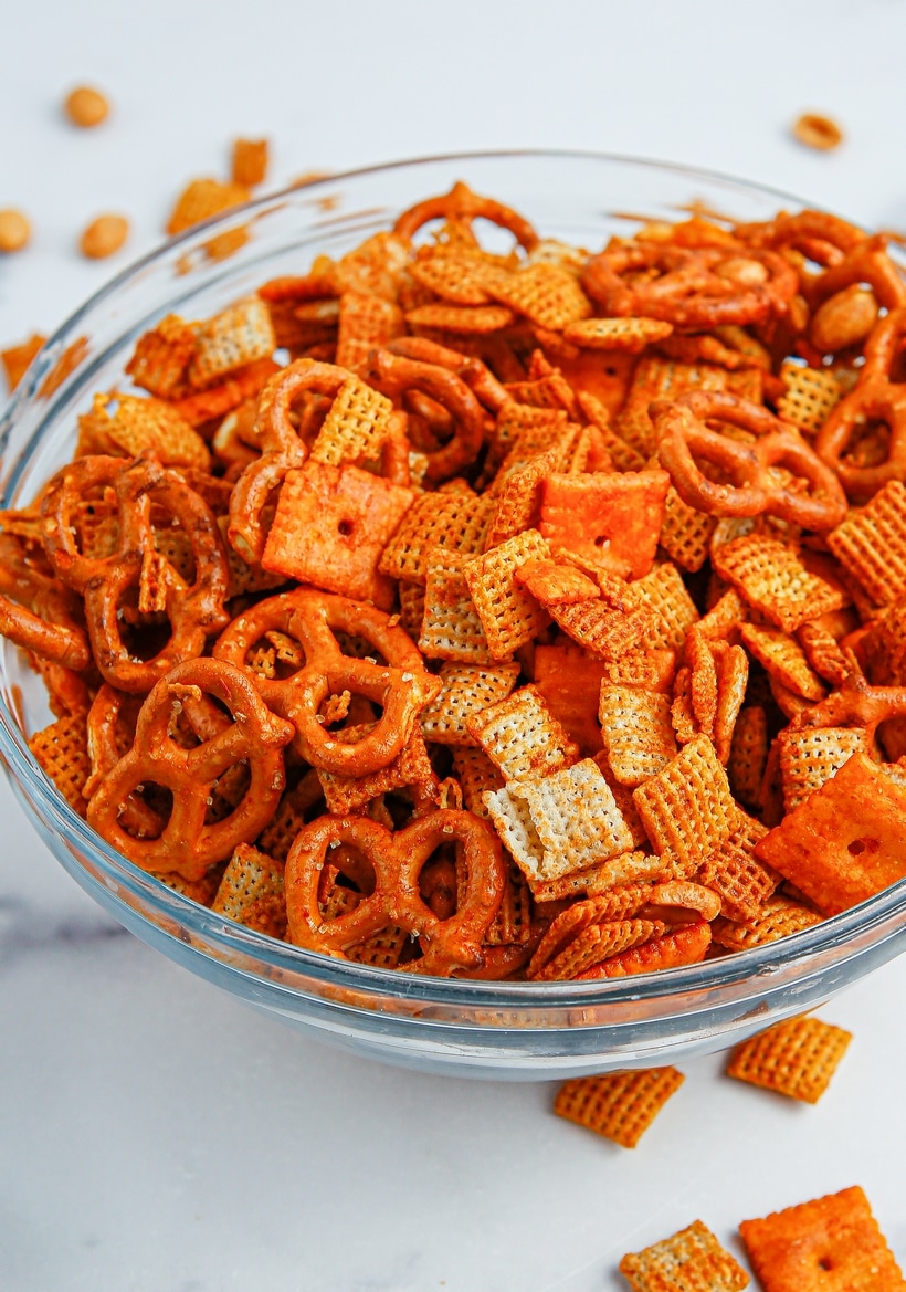 Chex mix in a clear round bowl, ready to be served.