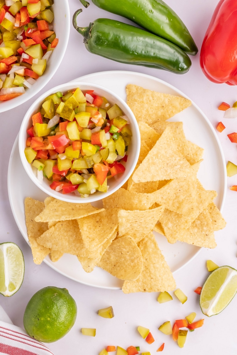 Pickle de Gallo - a tangy twist on the classic, this dill pickle salsa packs a puckering punch. This briny, garlicky, dip is great for dunking tortilla chips or used as a spread on burgers or sandwiches. pickle salsa recipe easy