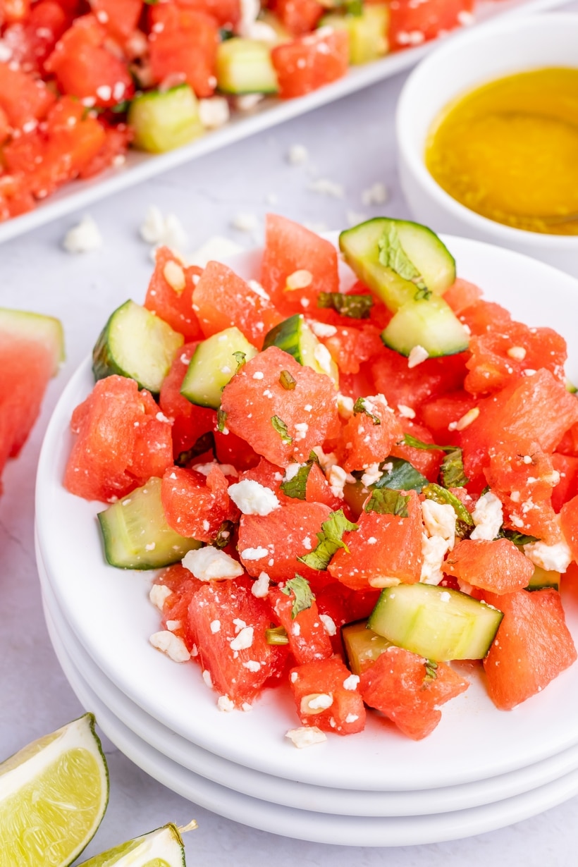 Watermelon mint salad topped with crumbled feta and fresh mint leaves Overhead view of watermelon feta mint salad with mint and feta visibly scattered on top