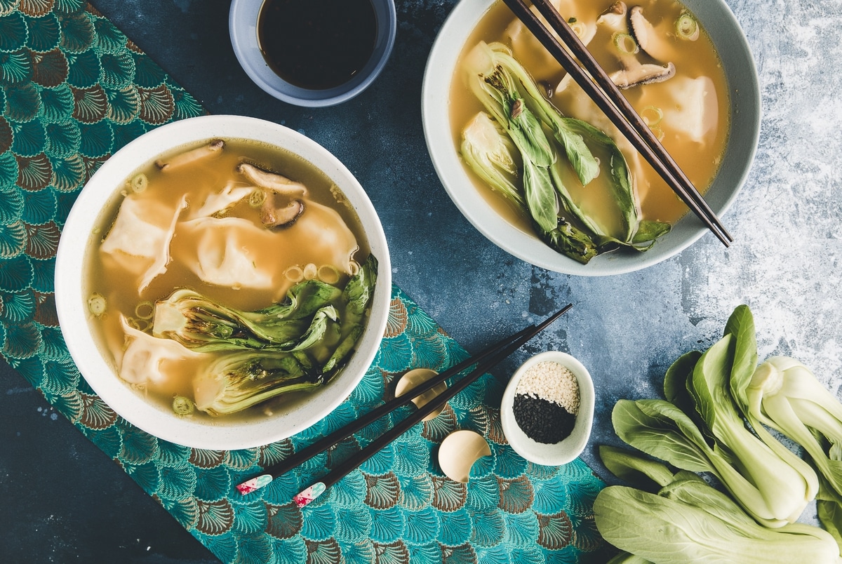 Two bowls of wonton soup .