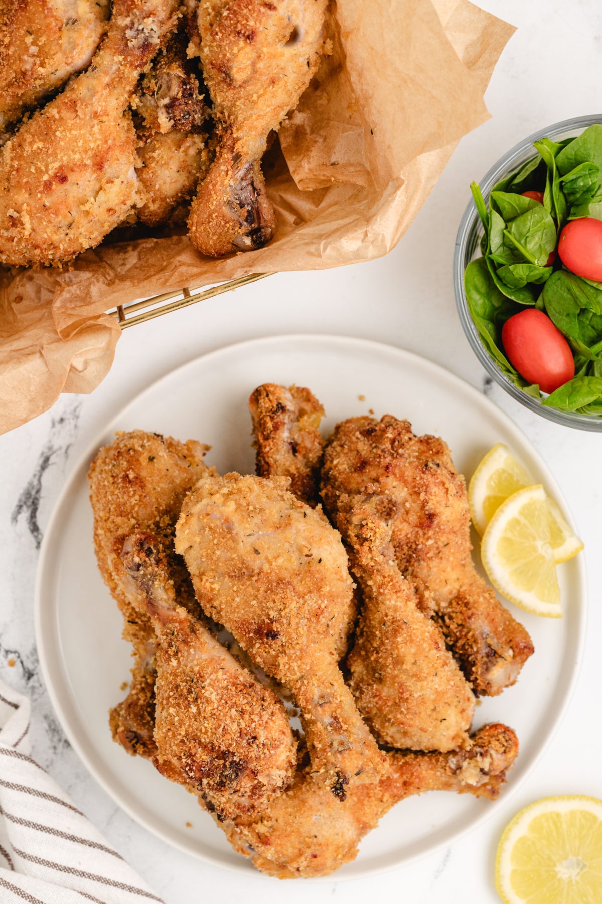 Lemonade Chicken Drumsticks lemonade chicken drumsticks with crispy panko coating served on a white plate with lemon wedges